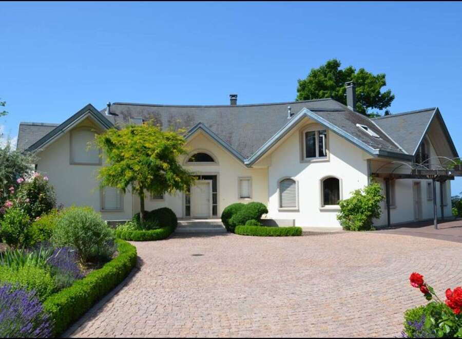 This stunning property boasts a beautifully designed exterior with a charming facade and well-manicured landscaping.