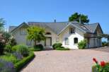This stunning property boasts a beautifully designed exterior with a charming facade and well-manicured landscaping.