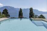 Experience luxury living with this stunning property featuring an infinity pool overlooking breathtaking mountain and lake views.
