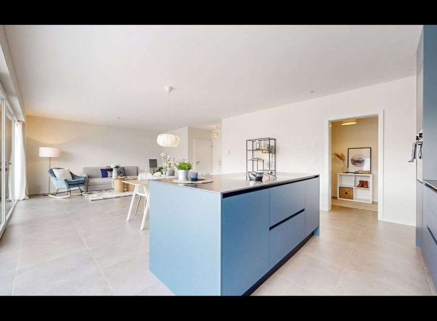 This modern kitchen boasts a sleek blue island, perfect for culinary endeavors and social gatherings.