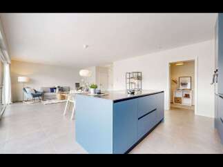 This modern kitchen boasts a sleek blue island, perfect for culinary endeavors and social gatherings.