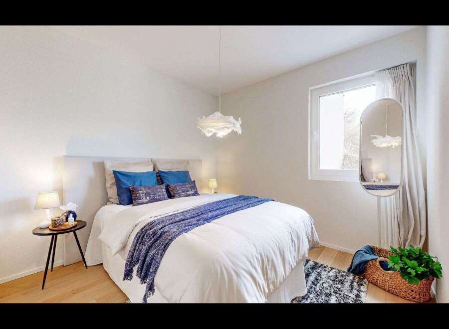 This inviting bedroom offers a serene retreat with its bright and airy ambiance.