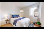 This inviting bedroom offers a serene retreat with its bright and airy ambiance.
