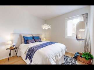 This inviting bedroom offers a serene retreat with its bright and airy ambiance.