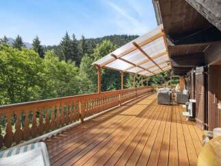 Enjoy breathtaking views from this stunning wooden deck, perfect for relaxation and entertaining.