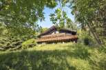 Nestled in a serene, wooded setting, this charming chalet offers a perfect blend of rustic elegance and modern comfort.