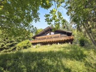 Nestled in a serene, wooded setting, this charming chalet offers a perfect blend of rustic elegance and modern comfort.
