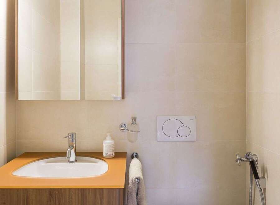 This modern bathroom features a sleek design with a stylish sink and a convenient mirror.