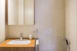 This modern bathroom features a sleek design with a stylish sink and a convenient mirror.