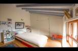This cozy bedroom features a comfortable bed with a crisp white duvet, perfect for a relaxing retreat.
