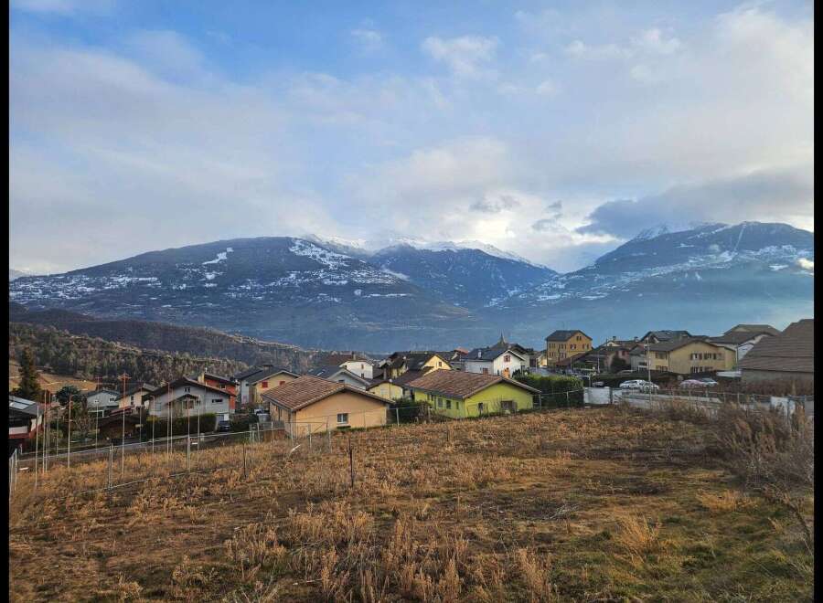 Discover the charm of this picturesque village nestled against a backdrop of majestic, snow-capped mountains.