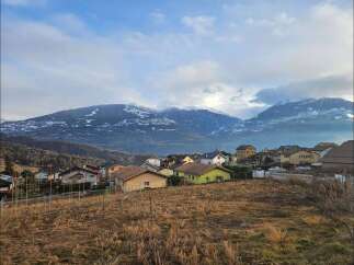Discover the charm of this picturesque village nestled against a backdrop of majestic, snow-capped mountains.