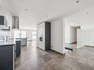 Discover modern living in this stunning property, featuring a sleek kitchen with stainless steel appliances and ample counter space.