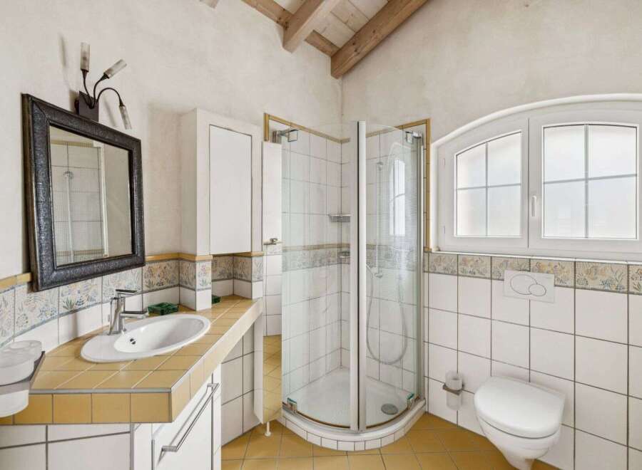 This charming bathroom features a bright and airy design, perfect for relaxation.