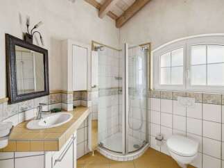 This charming bathroom features a bright and airy design, perfect for relaxation.