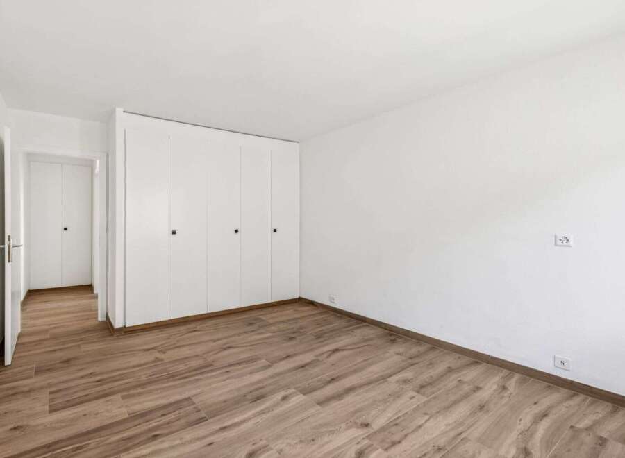 This bright and airy room features beautiful wood flooring and ample closet space, perfect for storage.