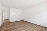 This bright and airy room features beautiful wood flooring and ample closet space, perfect for storage.