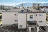 This stunning property boasts a modern design with a beautiful tiled roof and a pristine white exterior.