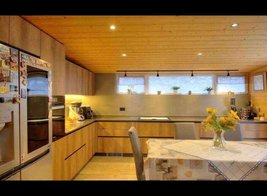 Step into this stunning kitchen, featuring sleek wooden cabinetry and a warm, inviting atmosphere.