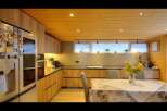 Step into this stunning kitchen, featuring sleek wooden cabinetry and a warm, inviting atmosphere.