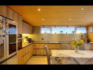 Step into this stunning kitchen, featuring sleek wooden cabinetry and a warm, inviting atmosphere.