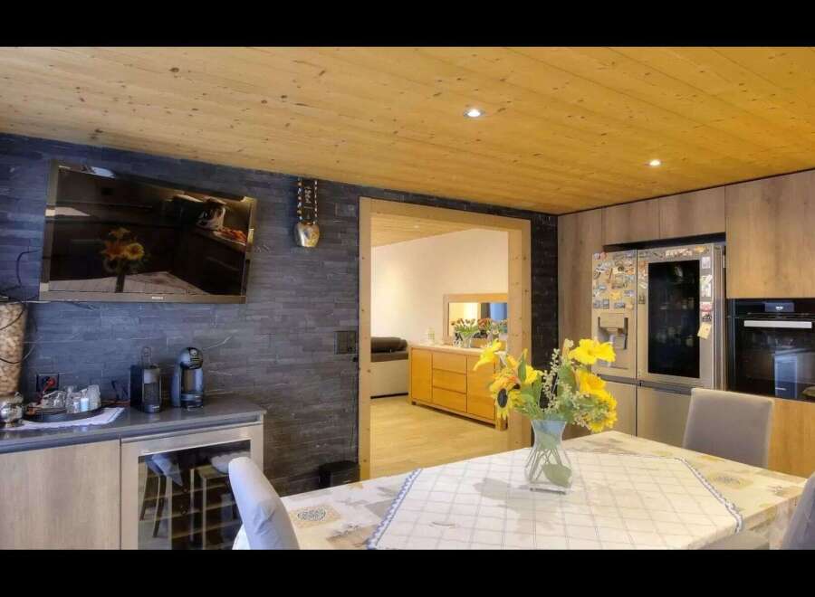 This stunning property boasts a modern kitchen with sleek cabinetry and top-of-the-line appliances.