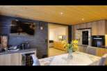 This stunning property boasts a modern kitchen with sleek cabinetry and top-of-the-line appliances.