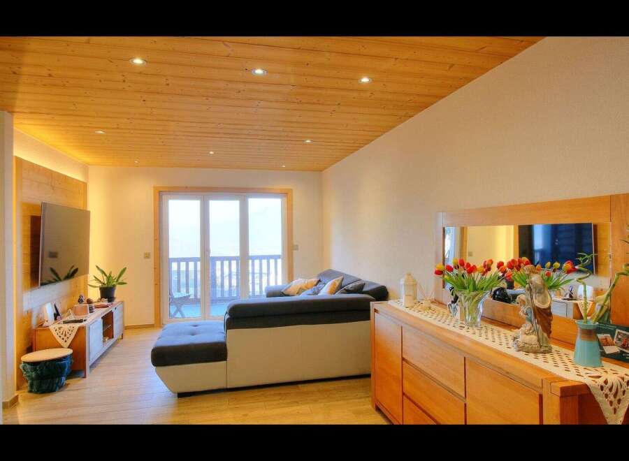This stunning living space boasts a warm and inviting ambiance, perfect for relaxation and entertaining.