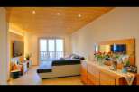 This stunning living space boasts a warm and inviting ambiance, perfect for relaxation and entertaining.