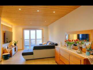 This stunning living space boasts a warm and inviting ambiance, perfect for relaxation and entertaining.