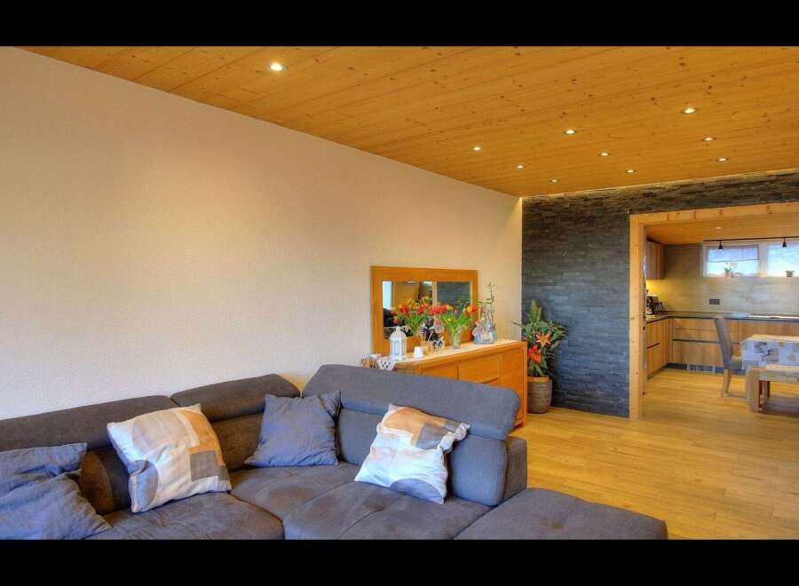 Discover the charm of this beautifully designed living space, featuring a cozy sectional sofa perfect for relaxation.