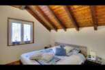 This charming bedroom features a cozy bed with plush pillows and a stylish patterned duvet.