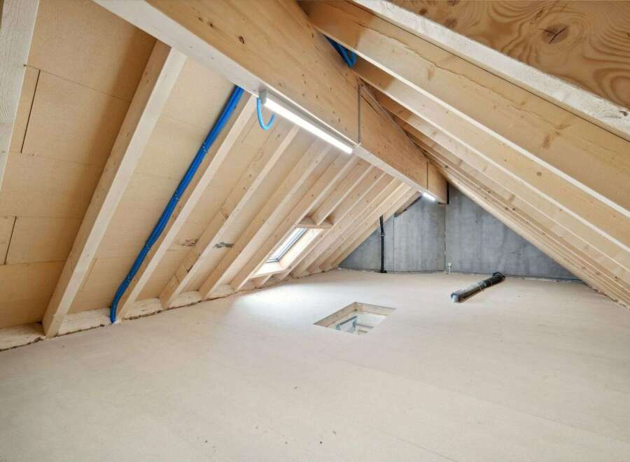 Explore the potential of this unfinished attic space, perfect for customization.