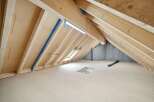 Explore the potential of this unfinished attic space, perfect for customization.