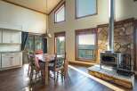 This stunning property boasts a rustic dining area with a beautiful wooden table and chairs, perfect for family gatherings.