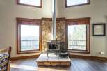 This stunning property boasts a cozy living space centered around a beautiful stone fireplace, perfect for those chilly evenings.