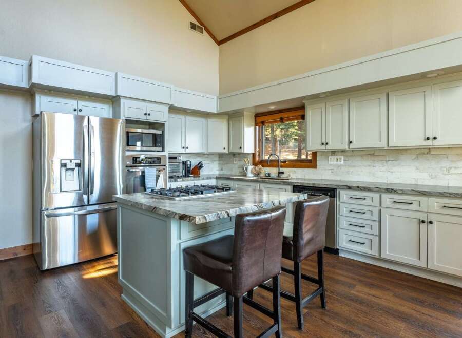 This stunning kitchen boasts a modern design with sleek stainless steel appliances and ample cabinet space.