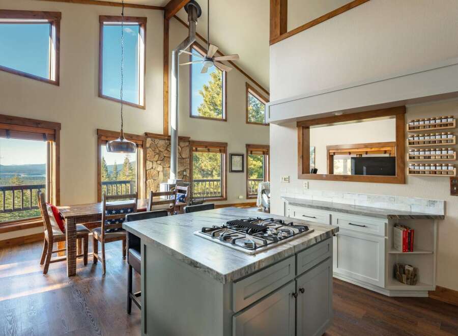 This stunning property boasts a spacious kitchen with a modern gas cooktop and ample counter space, perfect for culinary enthusiasts.