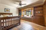 Step into this inviting bedroom, featuring a cozy window seat and ample storage.