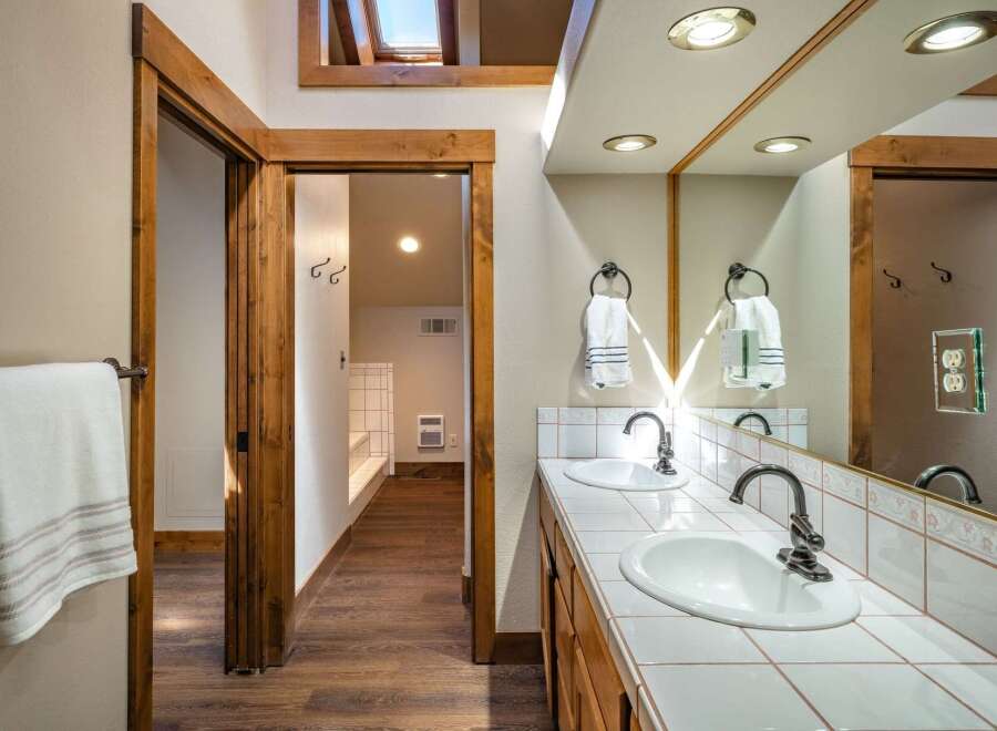 Step into this beautifully designed bathroom, featuring a double vanity with ample counter space and stylish fixtures.