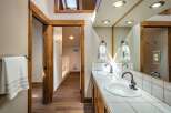Step into this beautifully designed bathroom, featuring a double vanity with ample counter space and stylish fixtures.