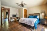 Step into this inviting bedroom, featuring a cozy bed with plush bedding and stylish decor.