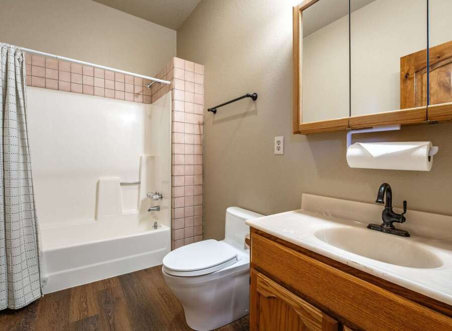 Step into this inviting bathroom featuring a classic design and functional layout.