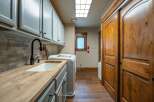 This stunning laundry room boasts a sleek design with ample storage and modern amenities.