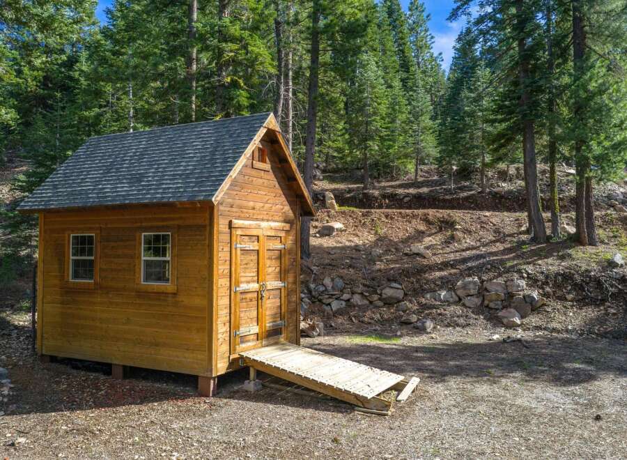 Nestled in a serene wooded setting, this charming cabin offers a tranquil escape.