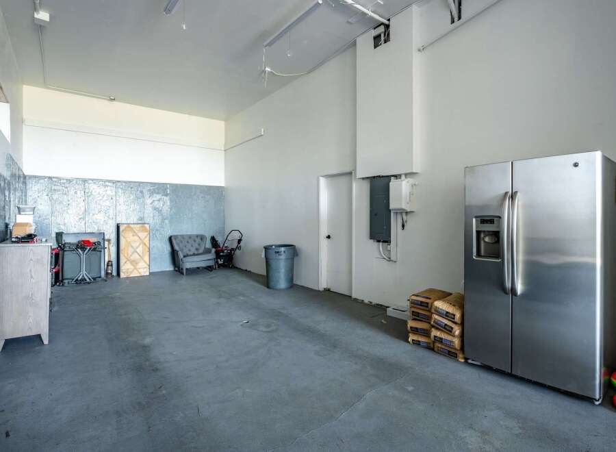 Discover the potential of this versatile space! This property boasts a spacious interior with high ceilings and ample room for various uses.