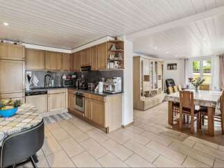 This charming property boasts a well-equipped kitchen with modern appliances and ample storage, perfect for culinary enthusiasts.