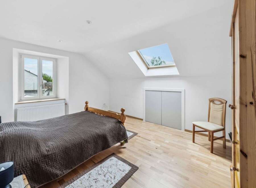 Discover the charm of this bright and airy bedroom, featuring a unique skylight that floods the space with natural light.