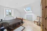 Discover the charm of this bright and airy bedroom, featuring a unique skylight that floods the space with natural light.