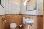 Step into this charming bathroom, featuring a classic design with tiled walls and a cozy atmosphere.